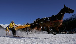 Skiers are pulled by horses in the skijoring race during the White Turf race. Photo by Scott Barbour/Getty Images.