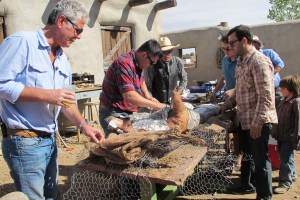 Anthony Bourdain helps to prepare a whole smoked hog in New Mexico, US