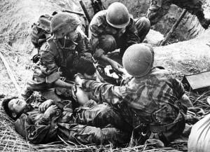 South Korean infantrymen tend to their wounded fellow soldier, 1952 (credit: Getty)