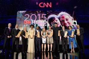 NEW YORK, NY - NOVEMBER 17: Host Anderson Cooper (L) poses with 2015 CNN Heros at CNN Heroes 2015 - Show at American Museum of Natural History on November 17, 2015 in New York City. 25619_022 (Photo by Kevin Mazur/Getty Images for CNN)